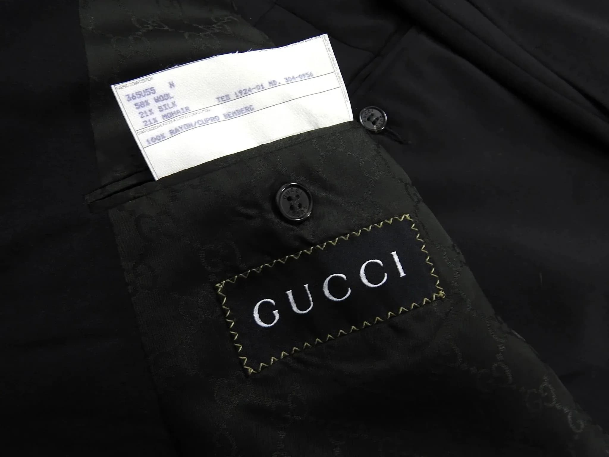 Black Gucci monogram lining with care tag listing Cupro Bemberg composition