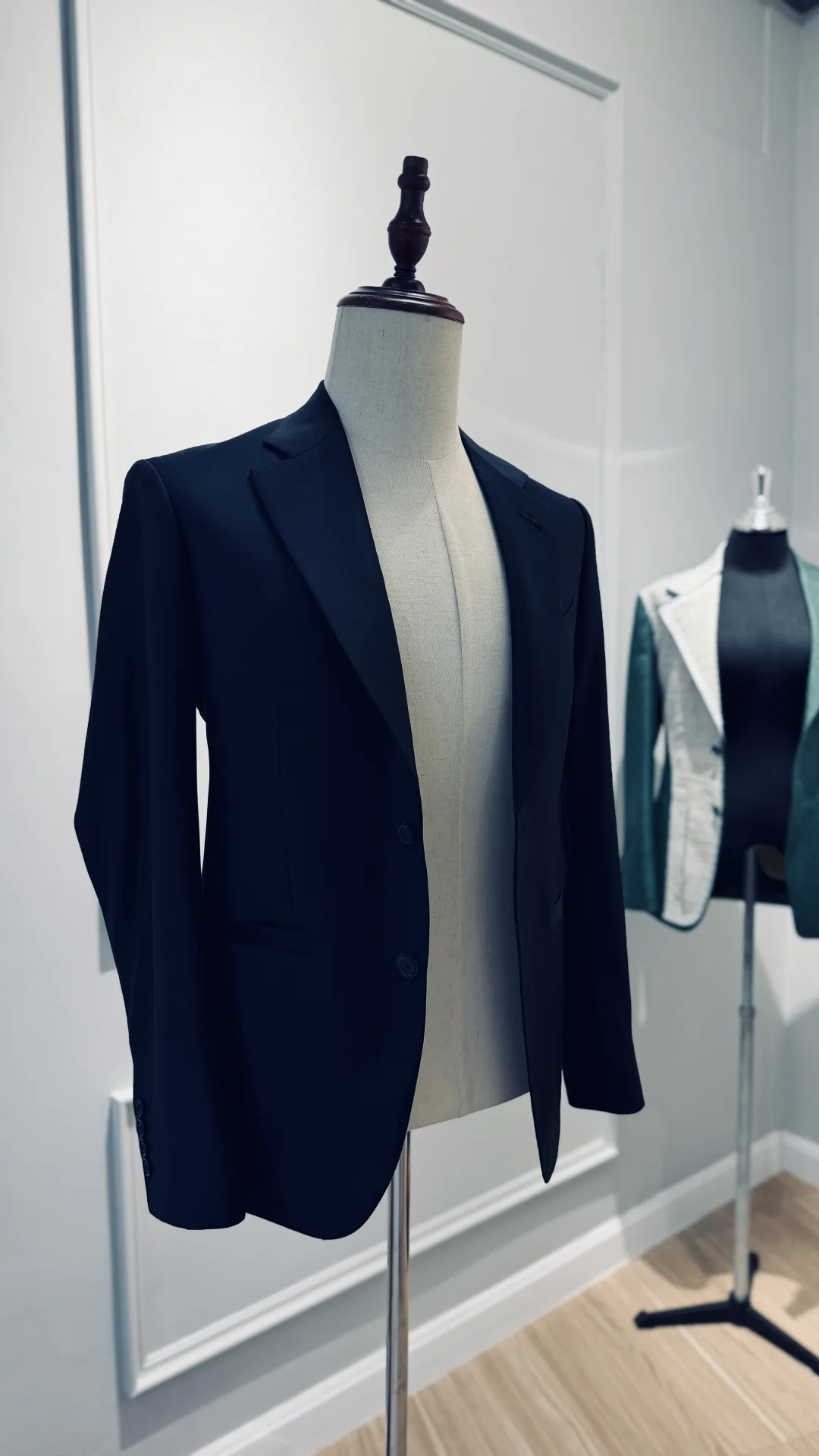 Navy two-button bespoke jacket on dress form in the Endel Bangkok fitting room