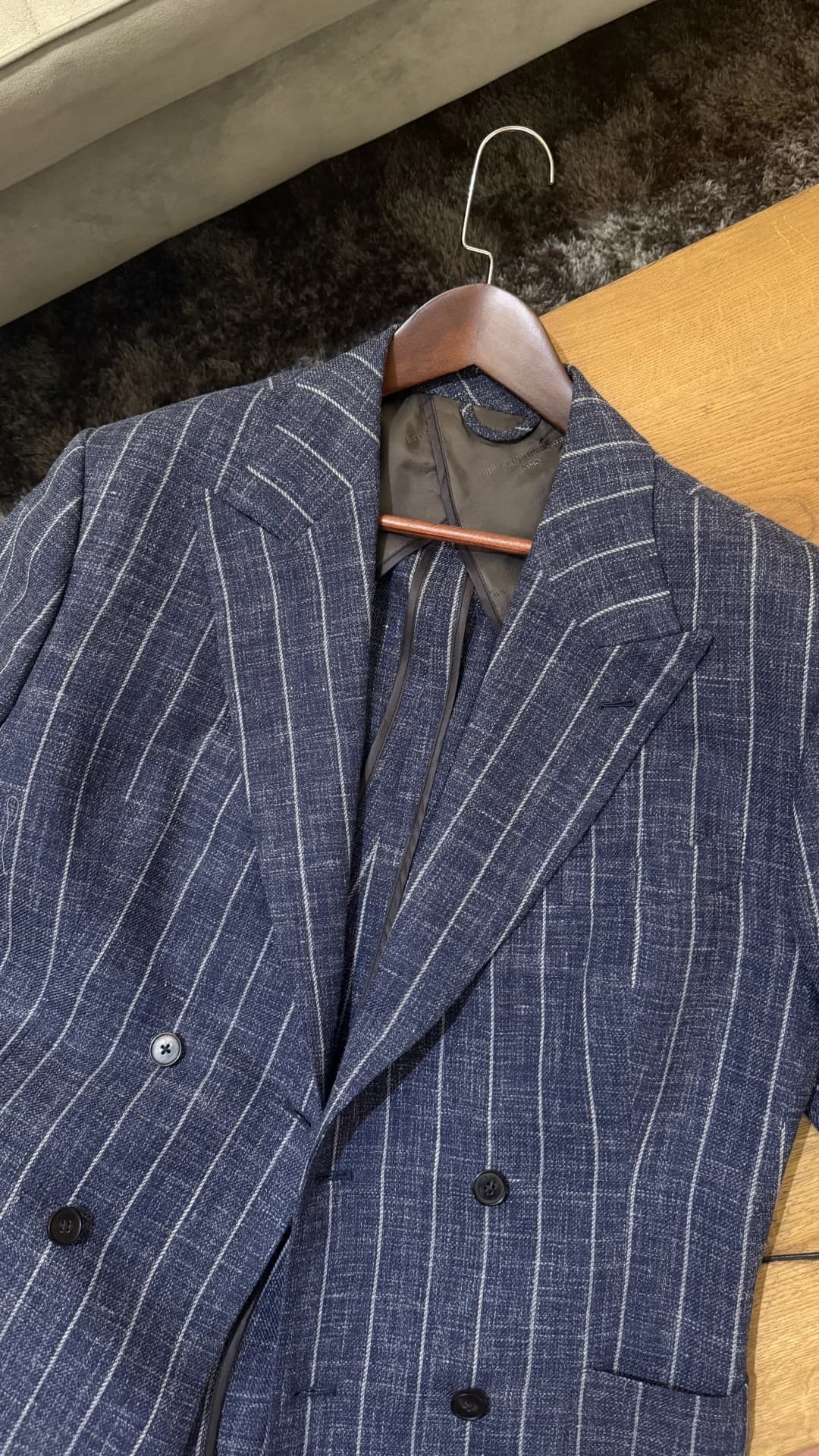 Navy chalk-stripe bespoke double-breasted jacket on wooden hanger at Endel Tailor Bangkok