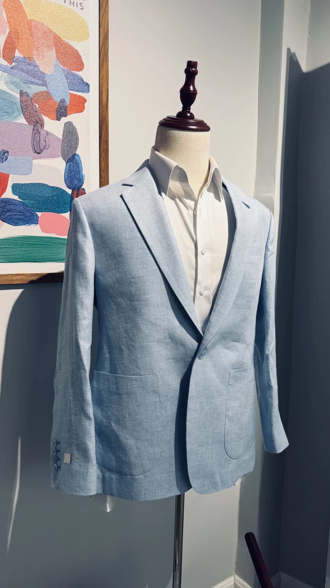 Light blue bespoke linen jacket on dress form with white shirt at Endel Bangkok atelier