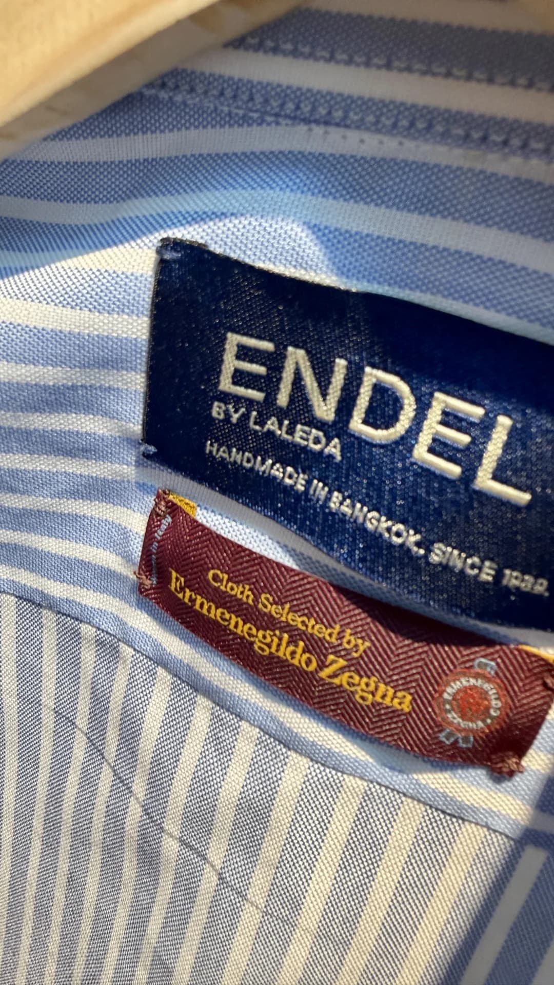 Endel by Laleda label and Ermenegildo Zegna cloth tag stitched into a striped bespoke shirt