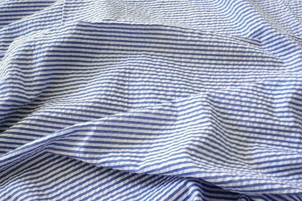 Blue and white striped seersucker showing its crinkled, puckered surface