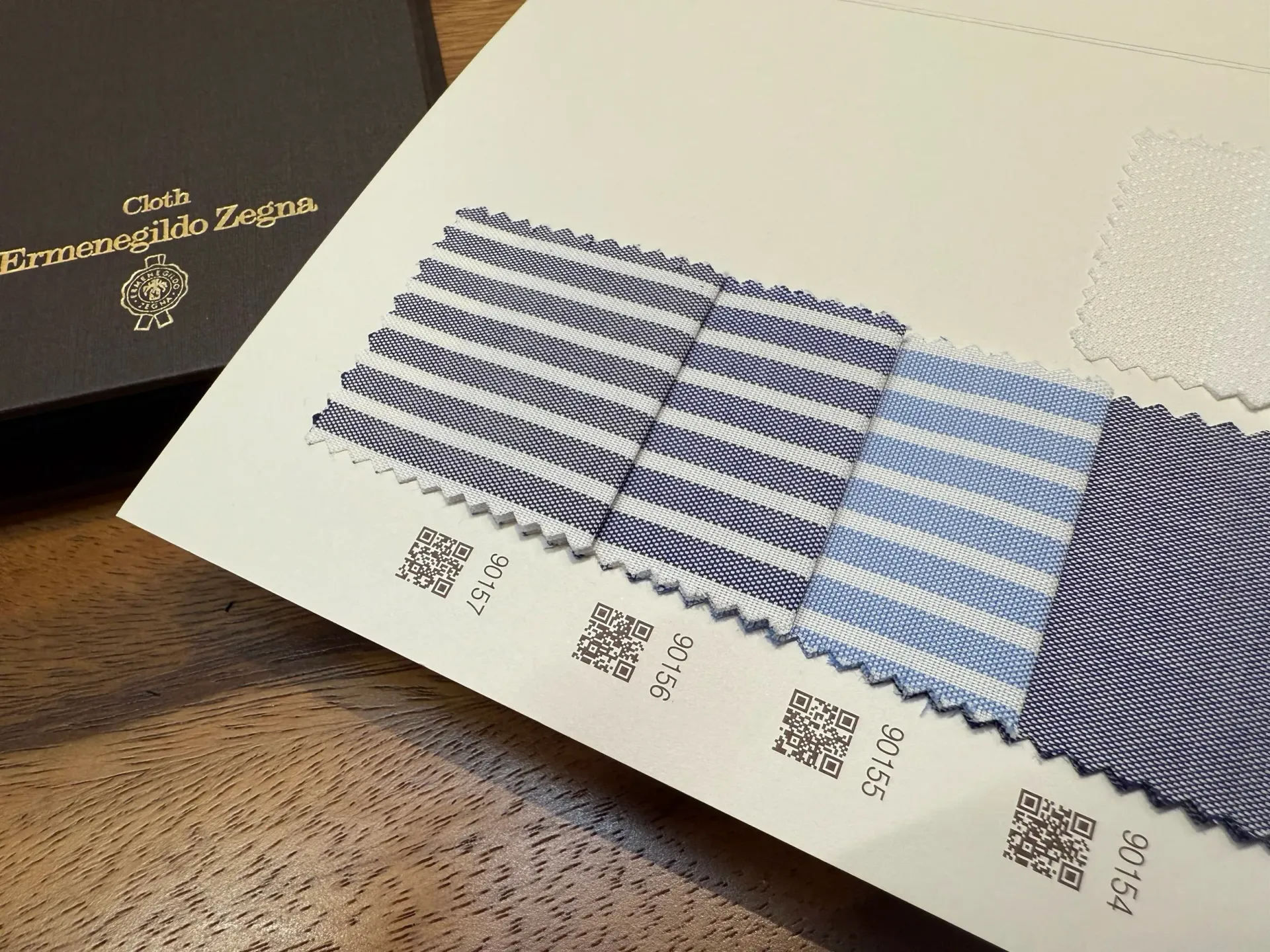 Ermenegildo Zegna Ceremony swatches: navy and light blue striped shirting fabrics with QR codes