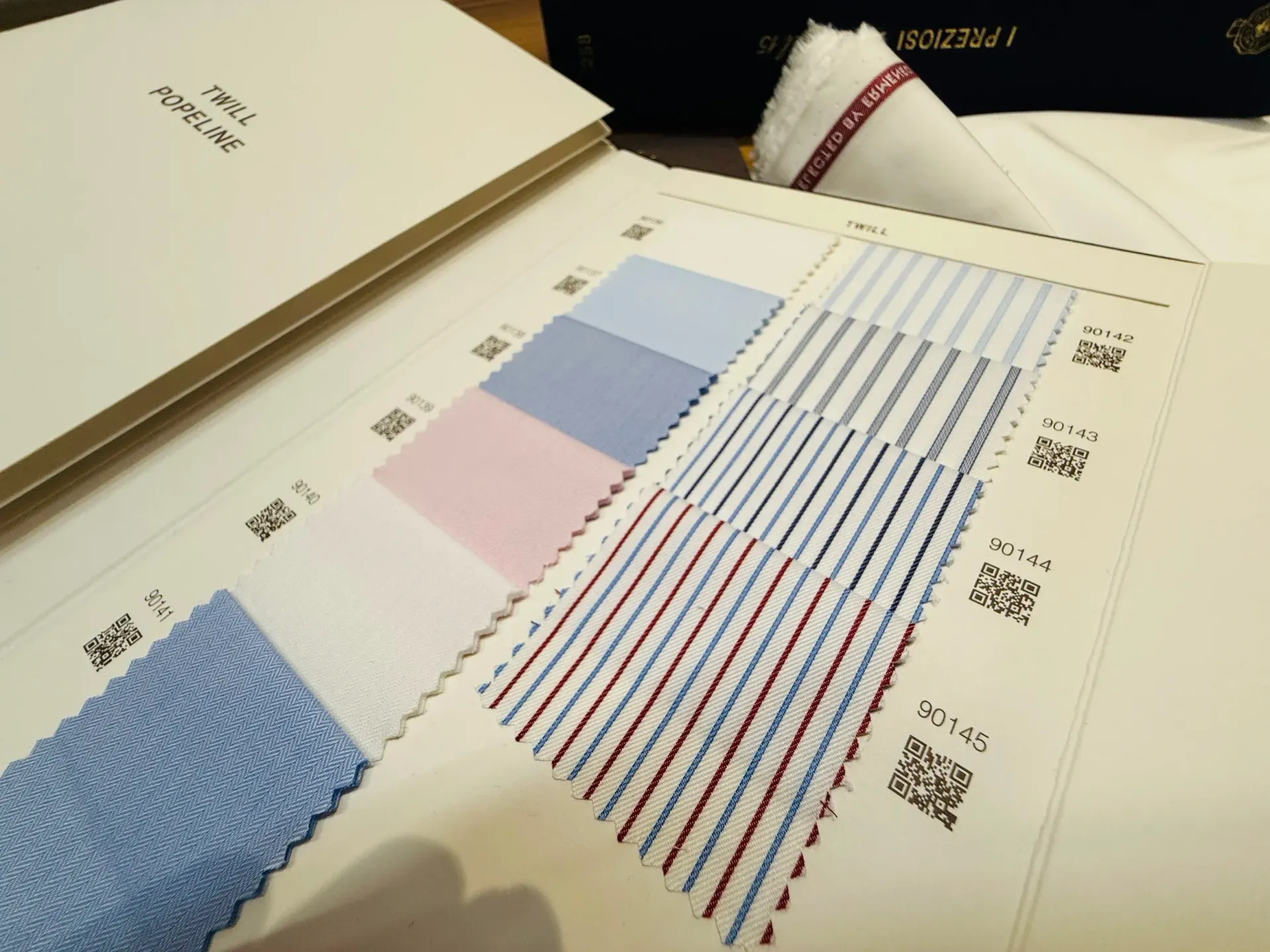 Zegna Popeline swatches in solid blue, pink, and fine red and blue stripes