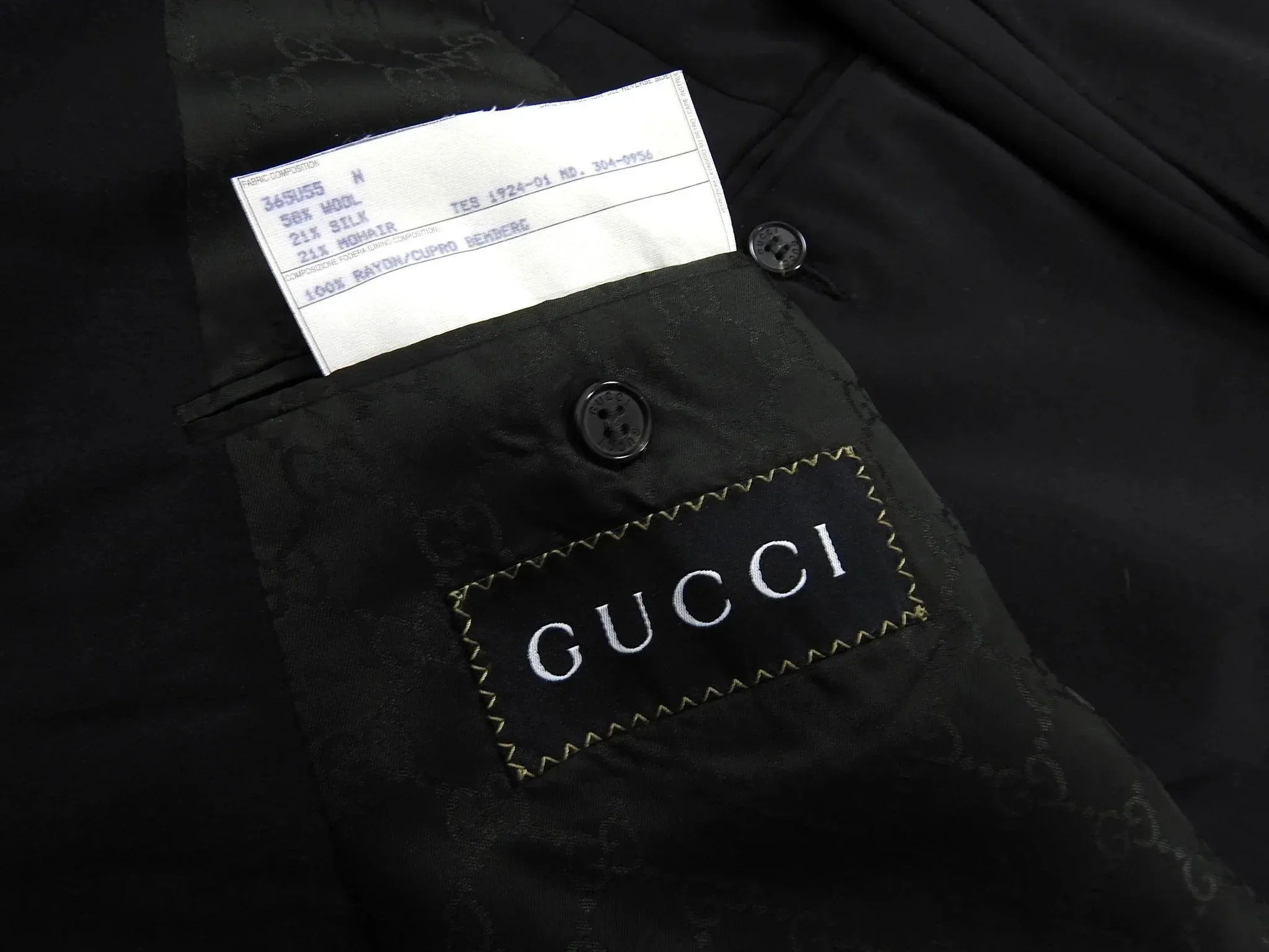 Black Gucci monogram lining with care tag listing Cupro Bemberg composition
