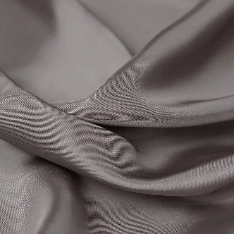 Soft silver-grey Bemberg cupro lining draping in fluid, silky folds