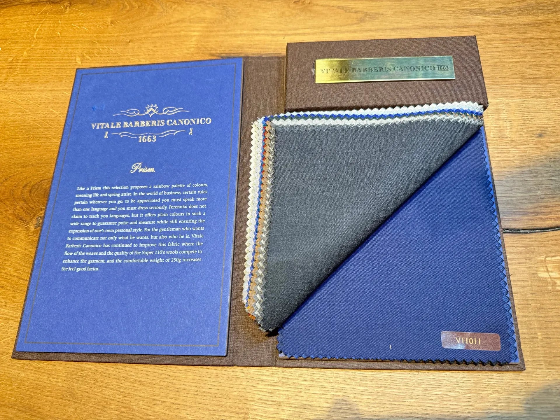 Vitale Barberis Canonico Prism swatch book with blue cover and blue, grey suiting swatches