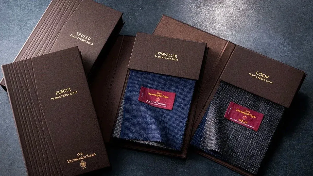 Zegna Trofeo, Traveller and Electa bunch books with navy and grey suiting swatches