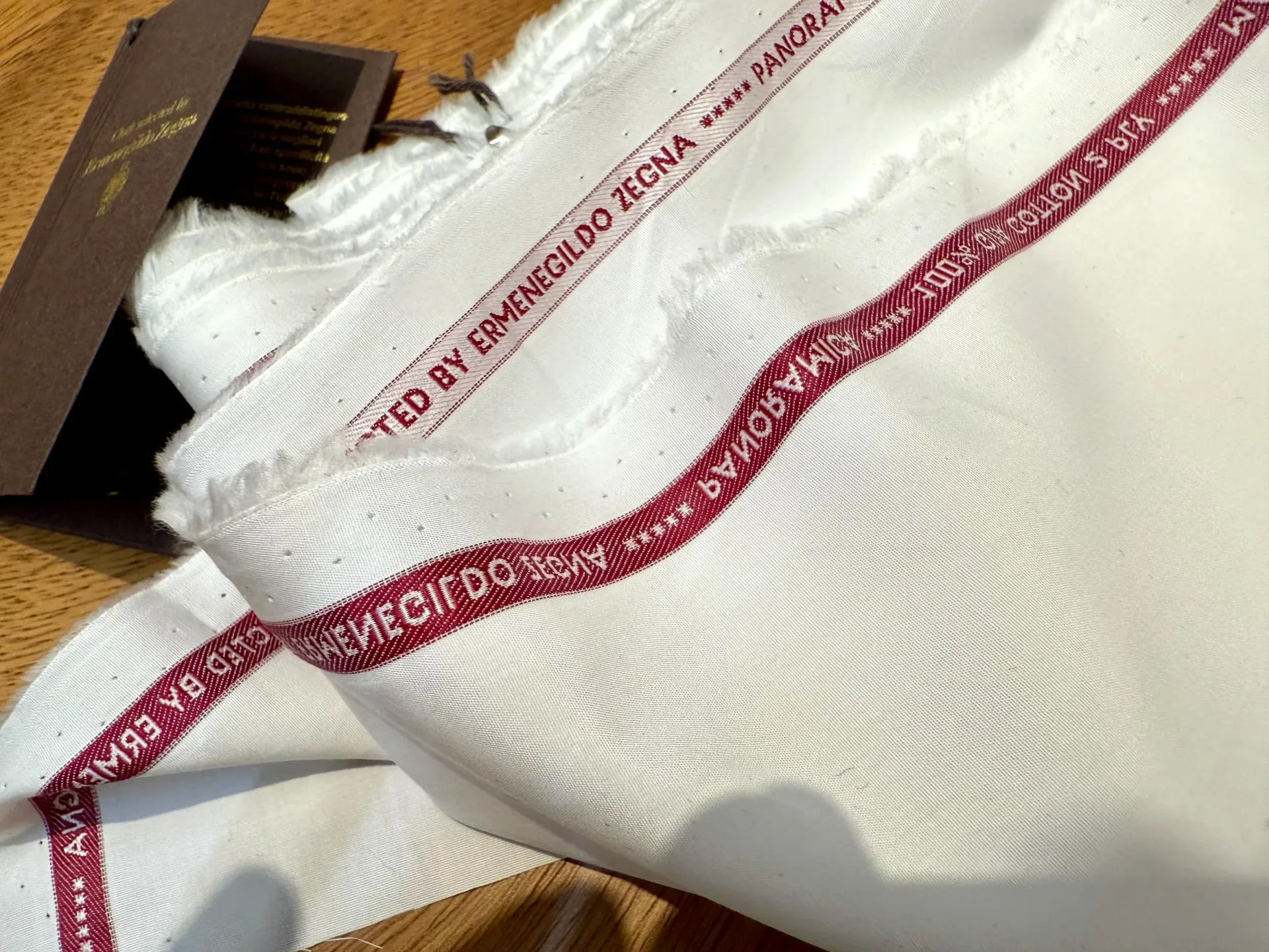 White Zegna Panoramica shirting fabric bolt with red Ermenegildo Zegna selvedge edge