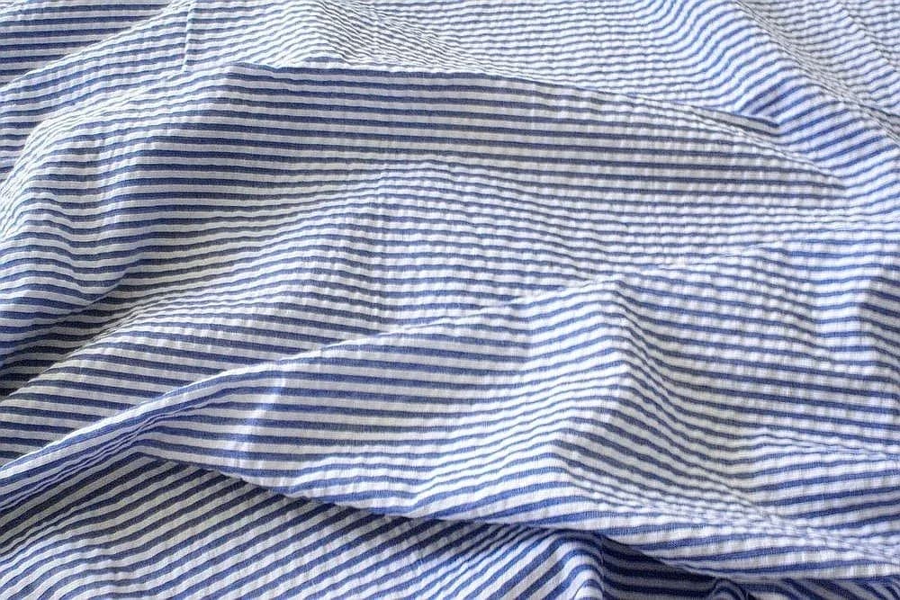 Blue and white striped seersucker showing its crinkled, puckered surface