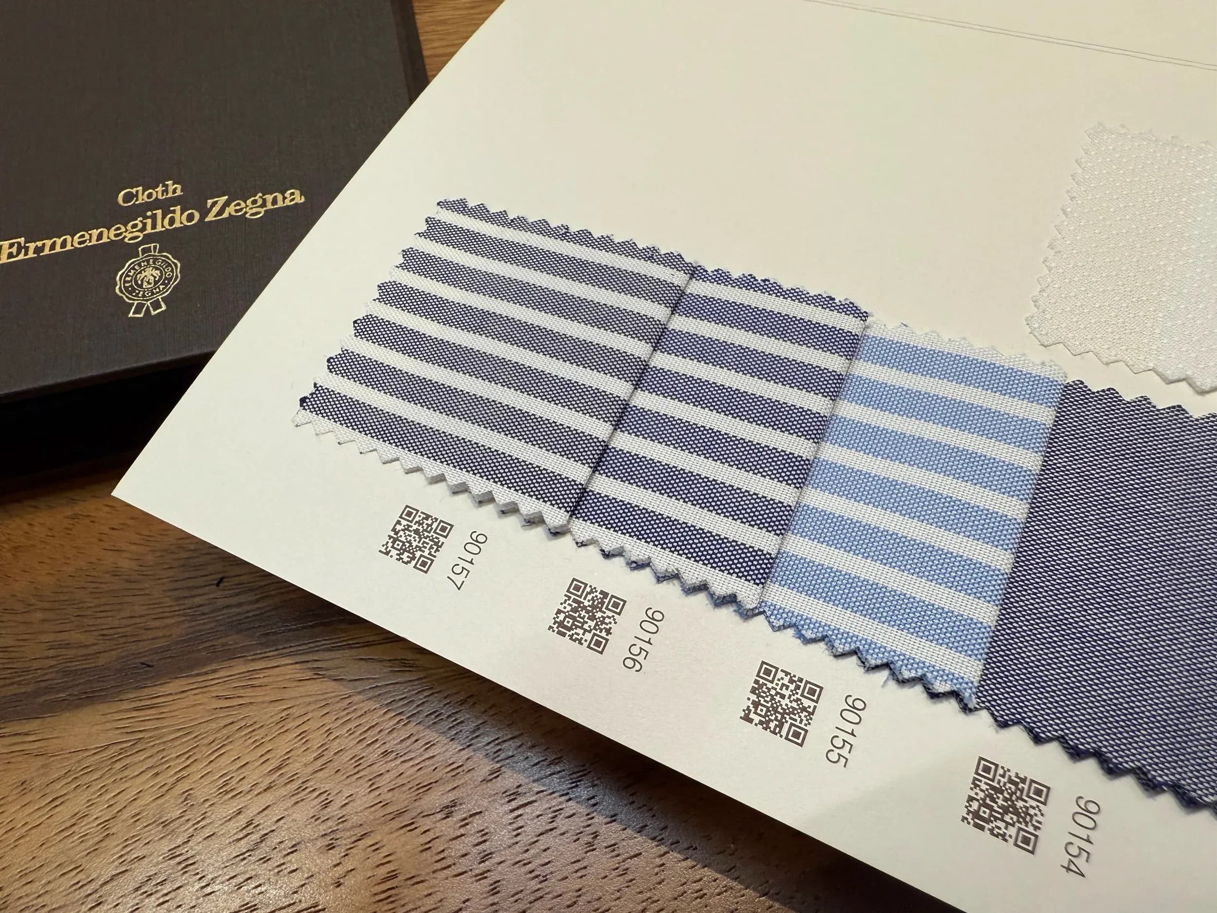 Ermenegildo Zegna Ceremony swatches: navy and light blue striped shirting fabrics with QR codes